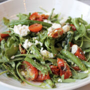 green beans, arugular, feta in a white bowl